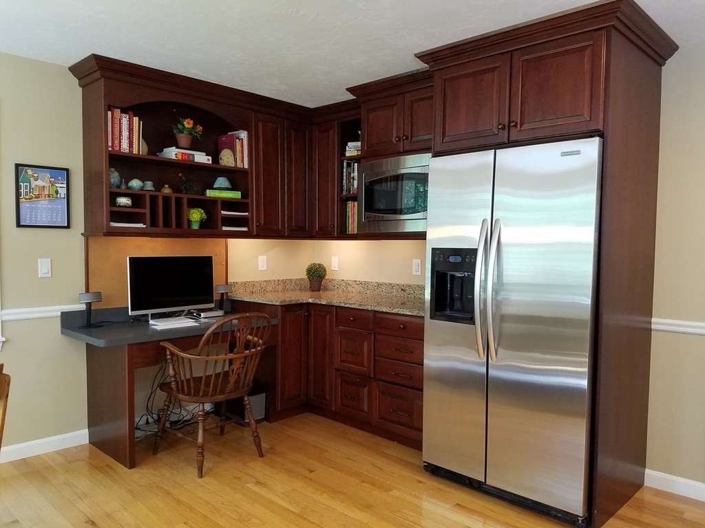 16 Cadorette Road Ashland, MA 01721 - Photo 8 of 29 a kitchen with stainless steel appliances granite countertop a refrigerator and a wooden cabinets
