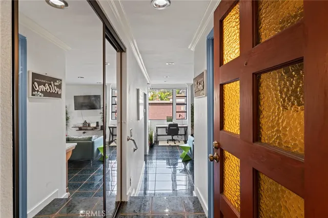 a hallway with a dining table and chairs