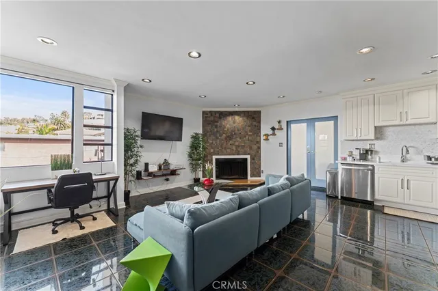 a living room with fireplace furniture and a flat screen tv