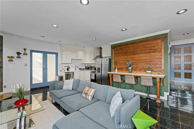 a living room with furniture kitchen and a large window