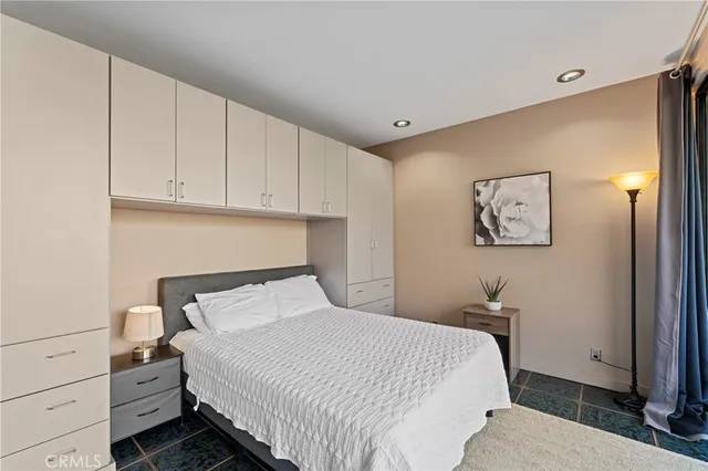 a bedroom with a bed and a cabinets