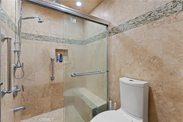 a bathroom with a shower a toilet and sink