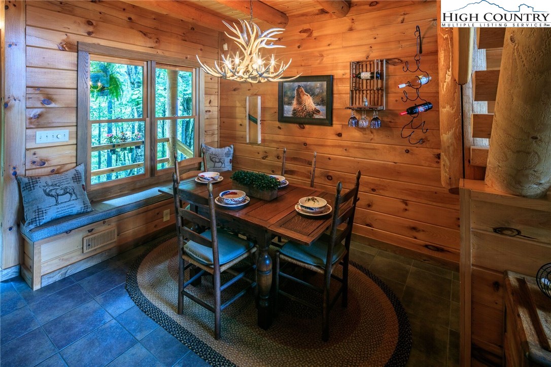 2137-2139 Little Laurel Road Creston, NC 28615 - Photo 17 of 49 a dining room with furniture and wooden floor