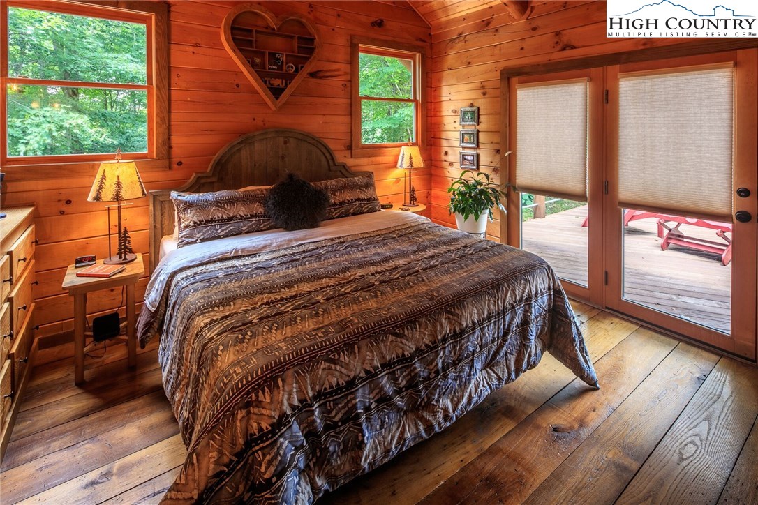 2137-2139 Little Laurel Road Creston, NC 28615 - Photo 23 of 49 a bedroom with a bed a window with outer view