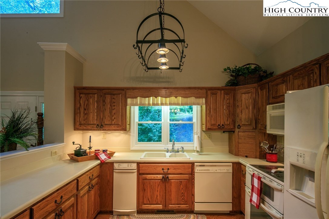 2137-2139 Little Laurel Road Creston, NC 28615 - Photo 37 of 49 a kitchen with a sink a stove and cabinets