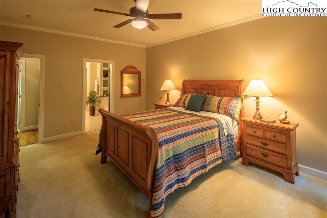 2137-2139 Little Laurel Road Creston, NC 28615 - Photo 39 of 49 a bedroom with a bed and a chandelier