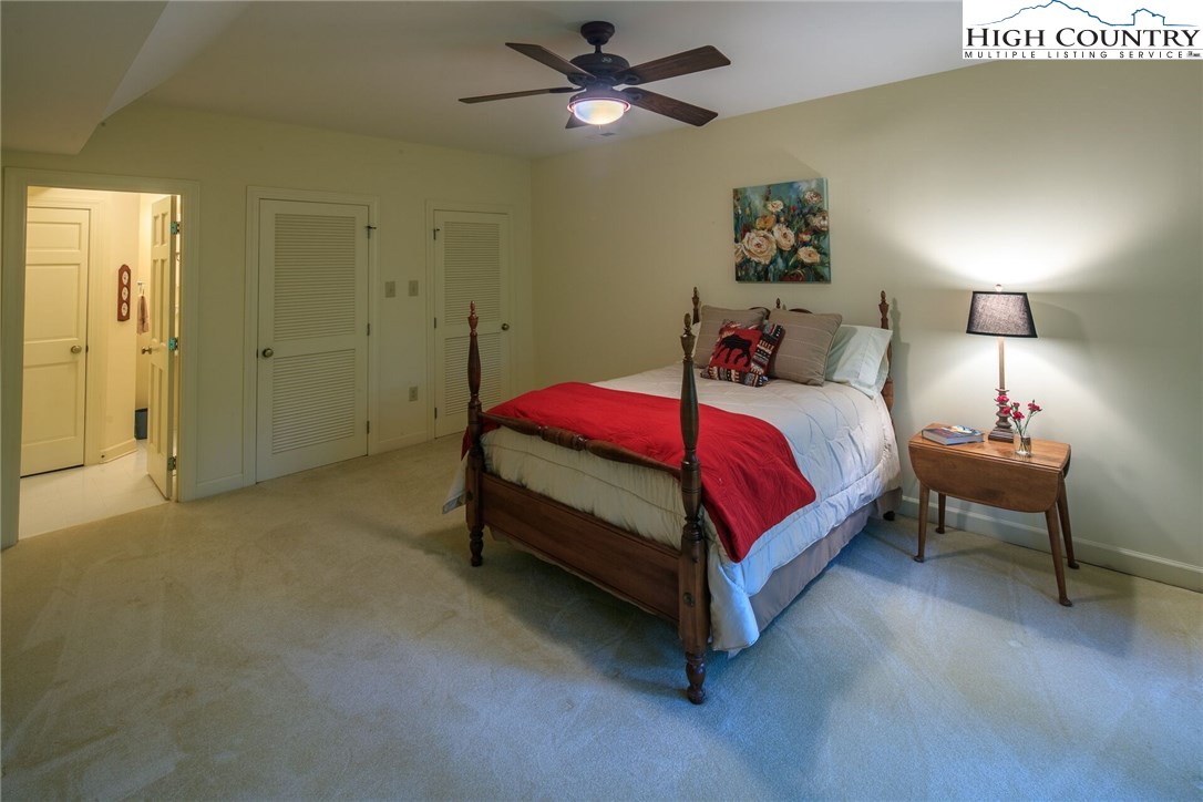 2137-2139 Little Laurel Road Creston, NC 28615 - Photo 42 of 49 a bedroom with a bed and a chandelier