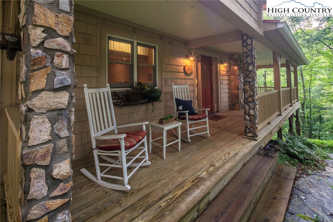 2137-2139 Little Laurel Road Creston, NC 28615 - Photo 43 of 49 a view of a patio with table and chairs with wooden floor and fence