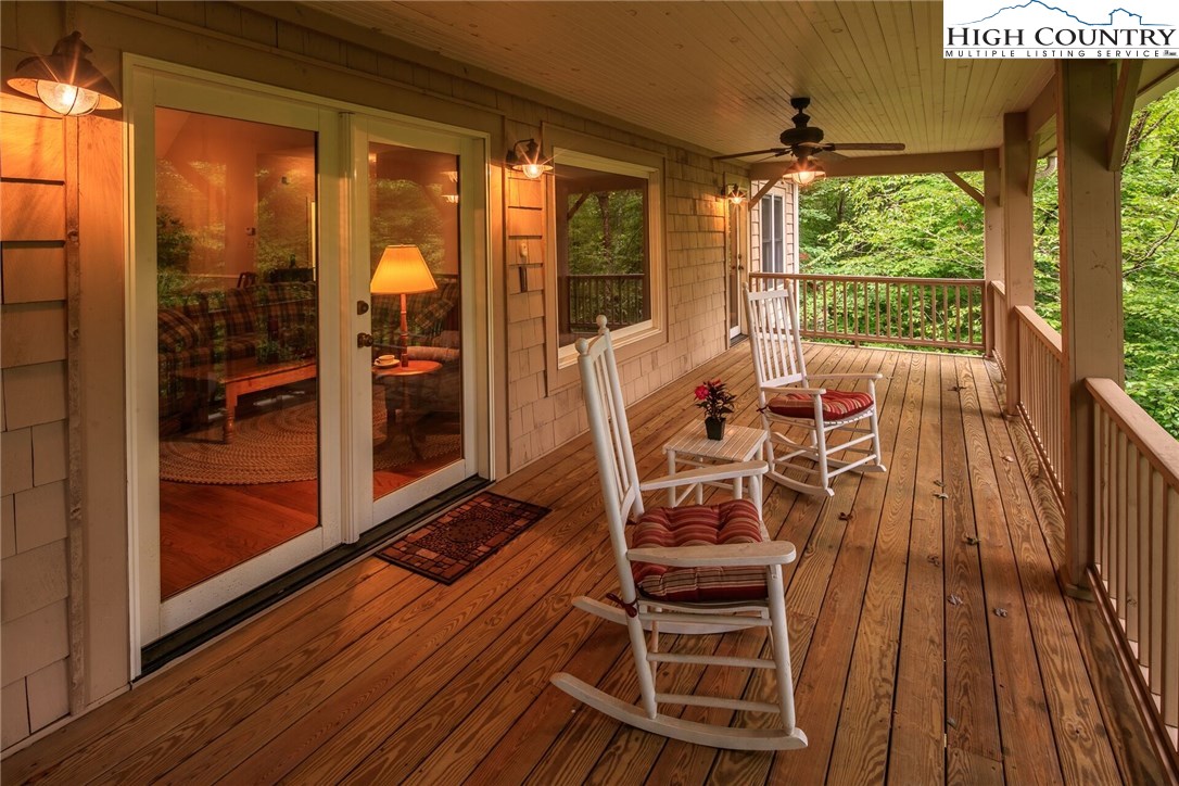 2137-2139 Little Laurel Road Creston, NC 28615 - Photo 44 of 49 a view of a balcony with chairs and wooden floor