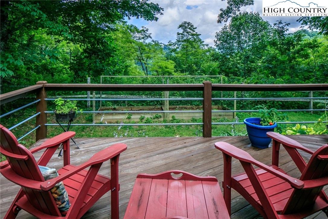 2137-2139 Little Laurel Road Creston, NC 28615 - Photo 5 of 49 a view of a chairs and table on the wooden deck