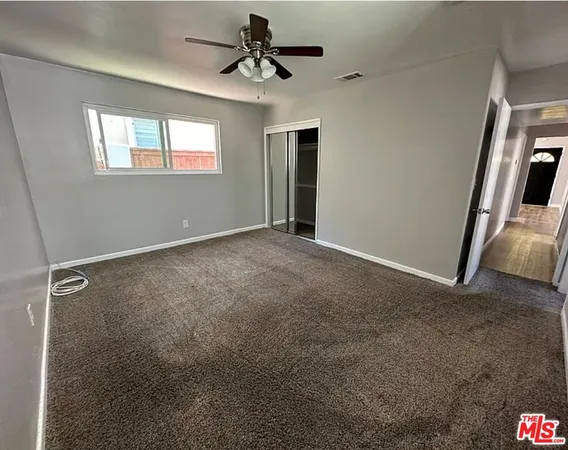 a view of room with a ceiling fan