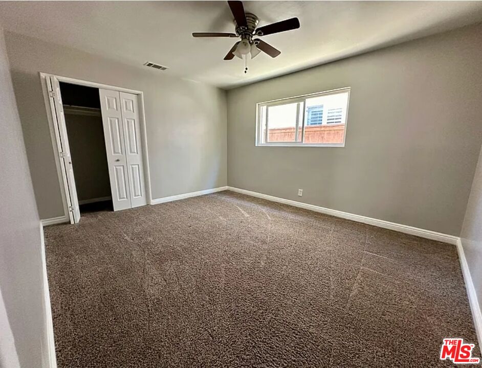 2221 Bataan Road, Unit A Redondo Beach, CA 90278 - Photo 13 of 16 a view of a livingroom with a ceiling fan & window