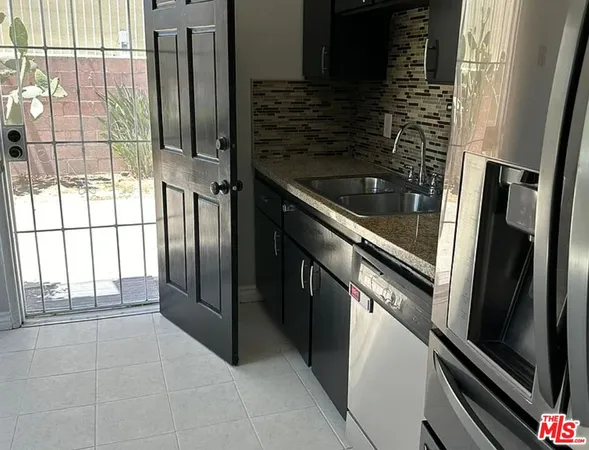 a kitchen with a refrigerator and a sink