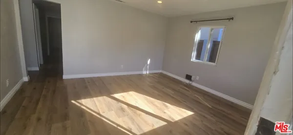 a view of wooden floor and windows in a room
