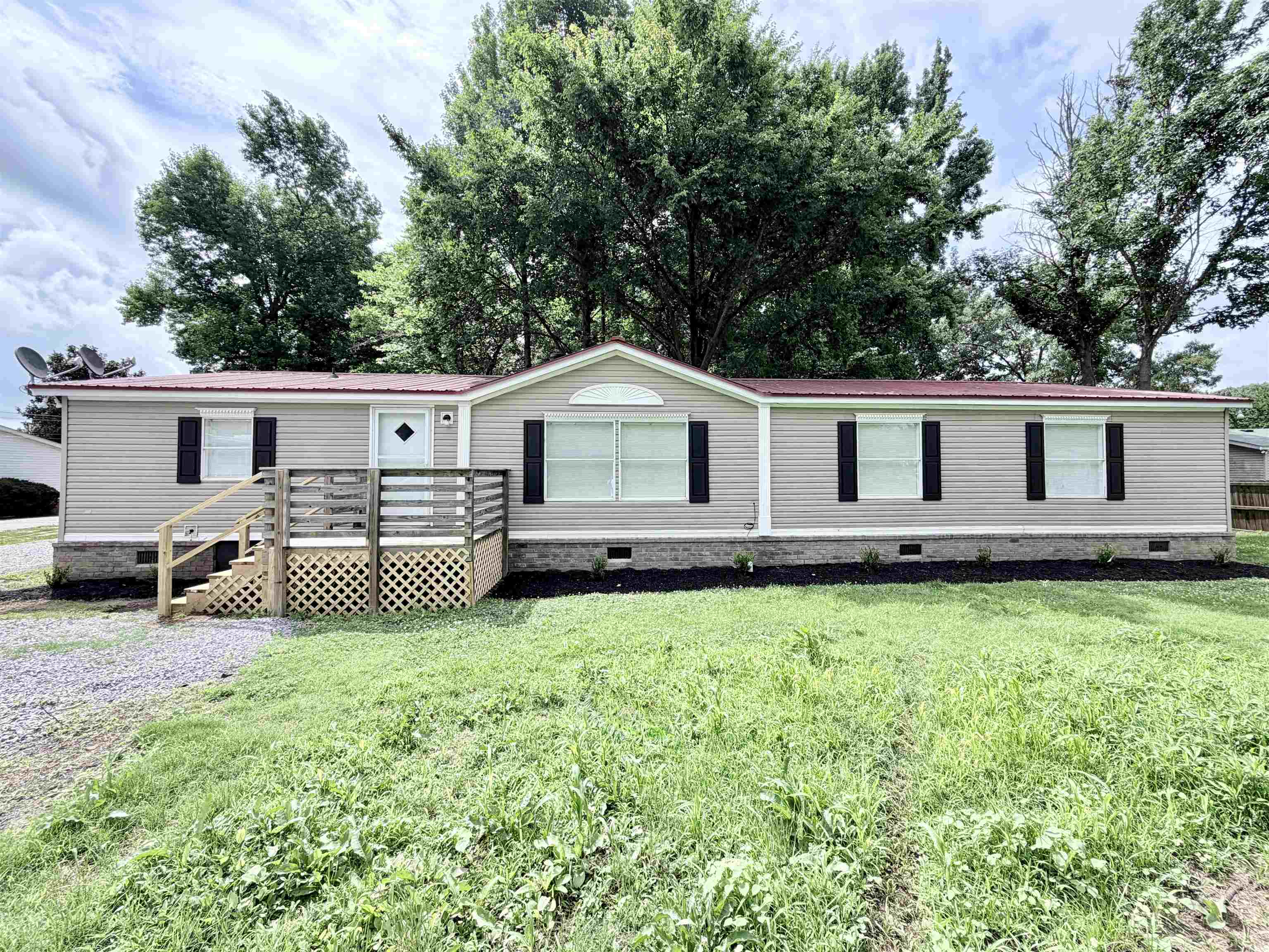 1655 Fayne Road Brighton, TN 38011 - Photo 1 of 28 Light-colored siding exterior with a red metal roof and dark shutters