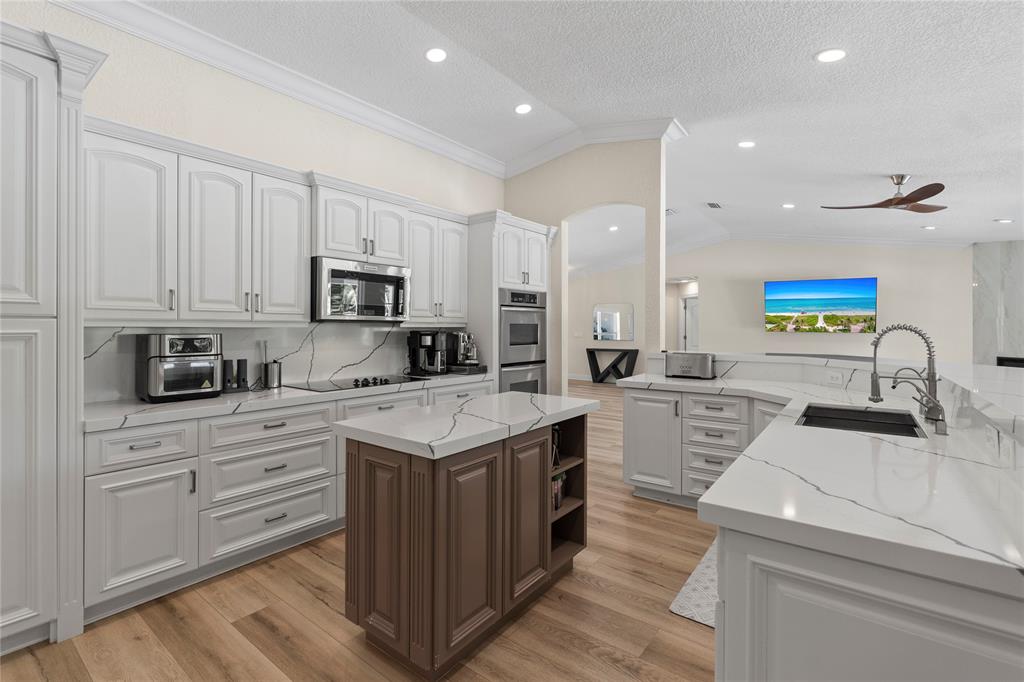 11391 Sundance Lane Boca Raton, FL 33428 - Photo 11 of 58 a kitchen with a sink stove and cabinets