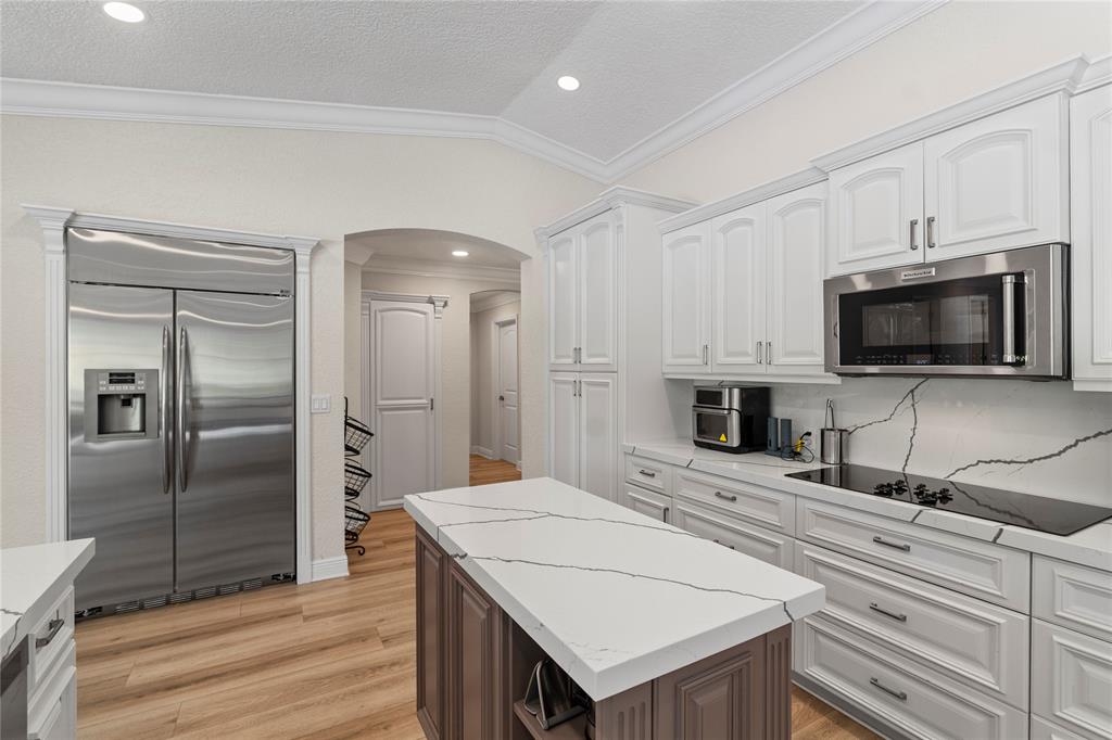11391 Sundance Lane Boca Raton, FL 33428 - Photo 13 of 58 a kitchen with kitchen island a sink appliances and cabinets