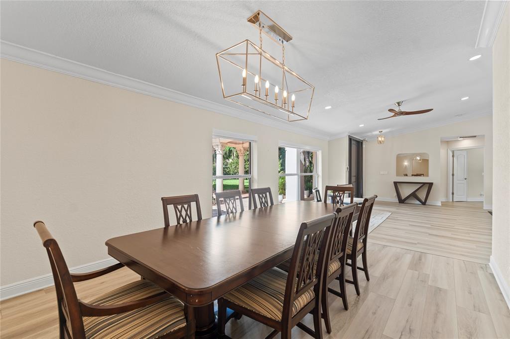 11391 Sundance Lane Boca Raton, FL 33428 - Photo 15 of 58 a view of a dining room with furniture and wooden floor
