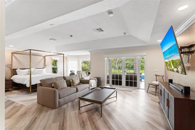 a large bedroom with a bed and large windows