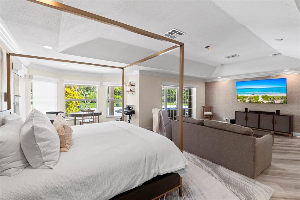 11391 Sundance Lane Boca Raton, FL 33428 - Photo 18 of 58 a large bedroom with a bed and large windows