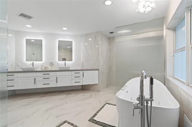 a bathroom with a tub a toilet and a shower