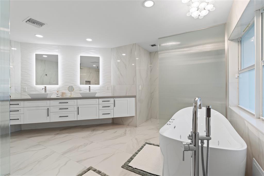 11391 Sundance Lane Boca Raton, FL 33428 - Photo 21 of 58 a bathroom with a double vanity sink a mirror and a shower