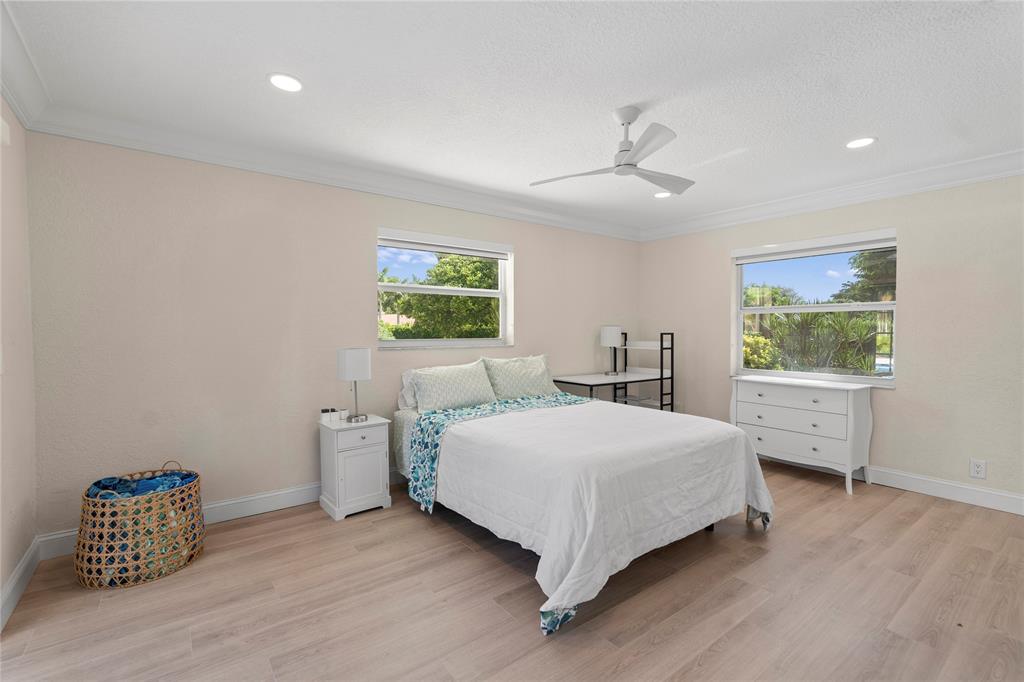 11391 Sundance Lane Boca Raton, FL 33428 - Photo 27 of 58 a bedroom with a bed and a table