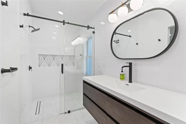 a living room with furniture kitchen and a large window