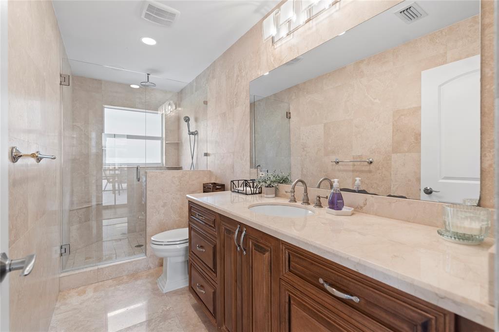 11391 Sundance Lane Boca Raton, FL 33428 - Photo 42 of 58 a bathroom with a double vanity sink toilet and shower