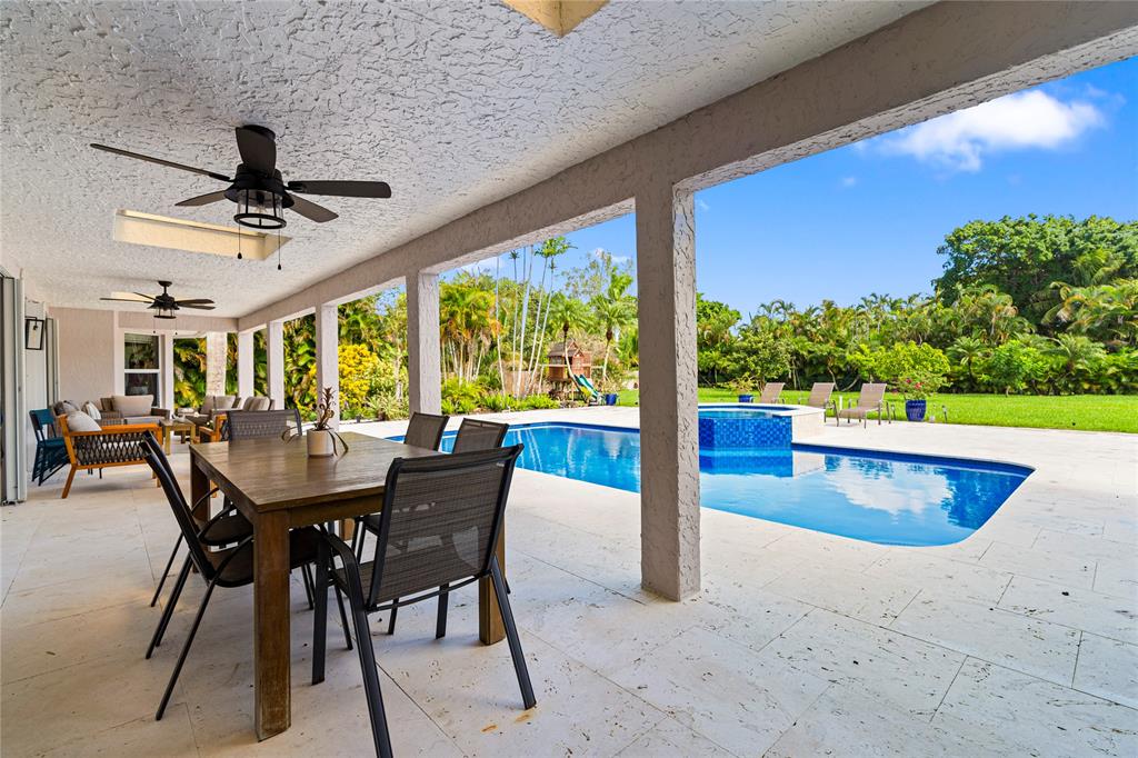 11391 Sundance Lane Boca Raton, FL 33428 - Photo 46 of 58 a view of a patio with a table chairs and backyard
