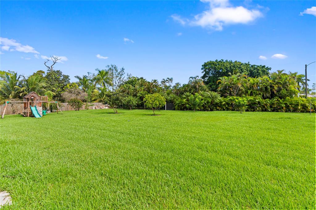 11391 Sundance Lane Boca Raton, FL 33428 - Photo 51 of 58 a view of a garden with a building in the background