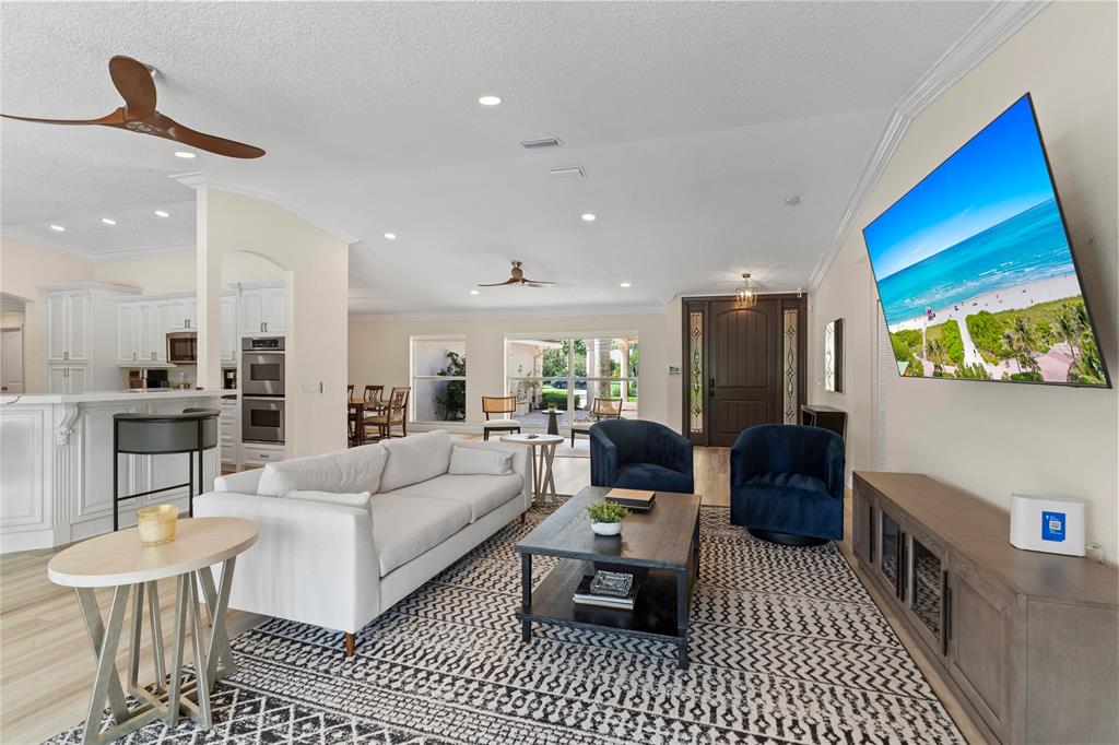 11391 Sundance Lane Boca Raton, FL 33428 - Photo 6 of 58 a living room with furniture a rug and a chandelier