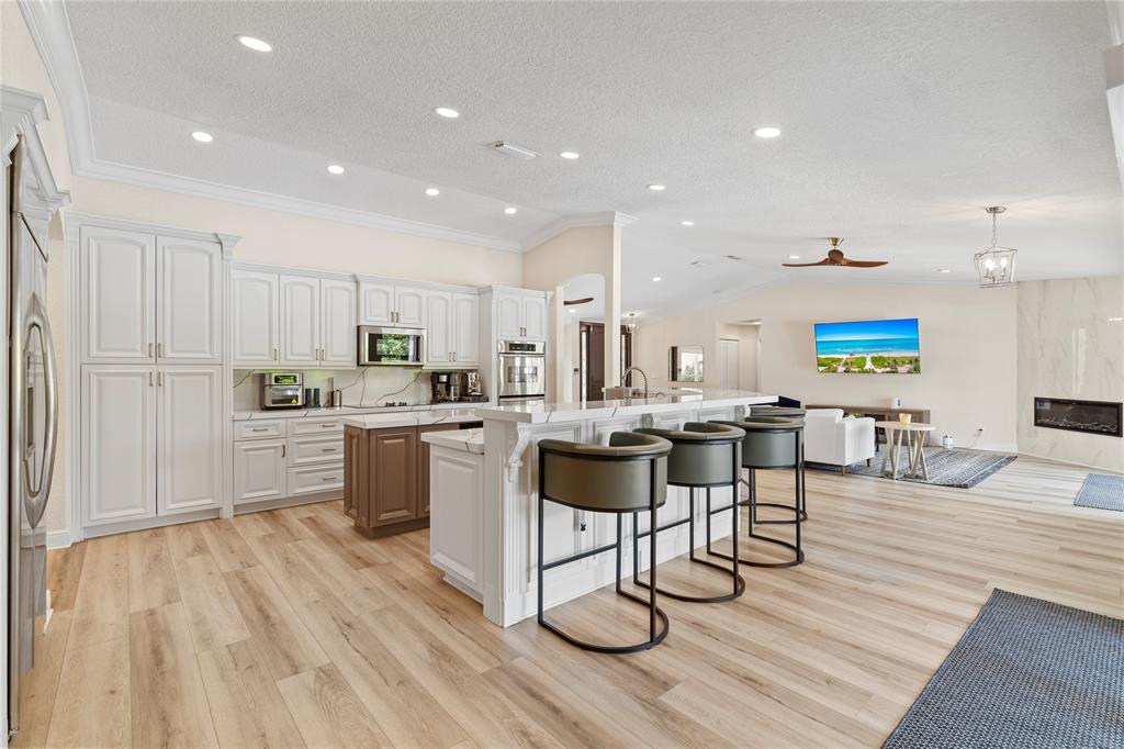 11391 Sundance Lane Boca Raton, FL 33428 - Photo 9 of 58 a kitchen with a sink cabinets and wooden floor