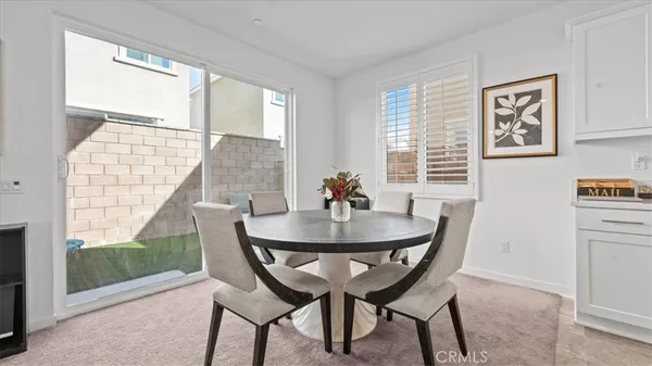 a view of a dining room with furniture and a window