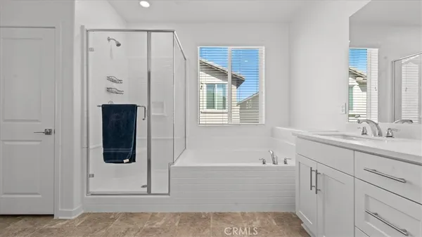 a bathroom with a tub sink and mirror