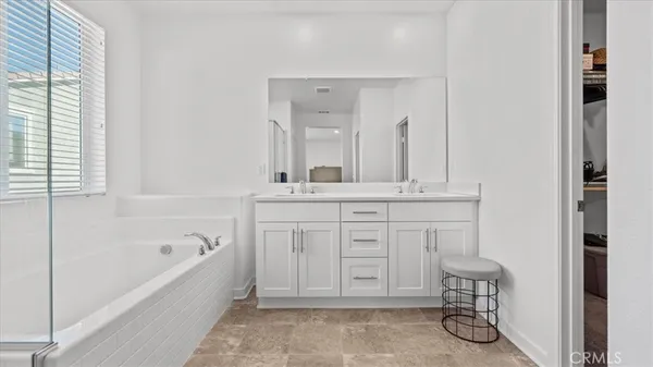 a bathroom with a bathtub sink and a mirror