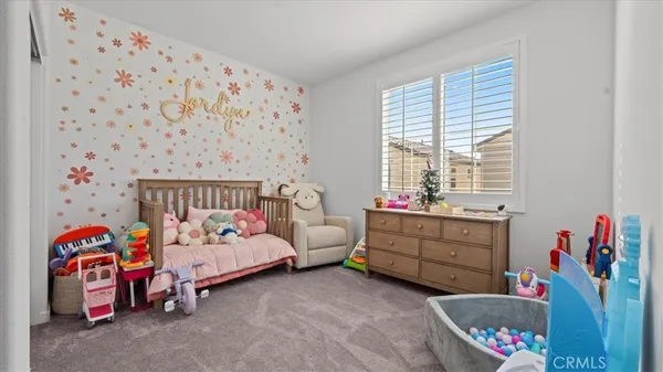 a bedroom with bed and a window