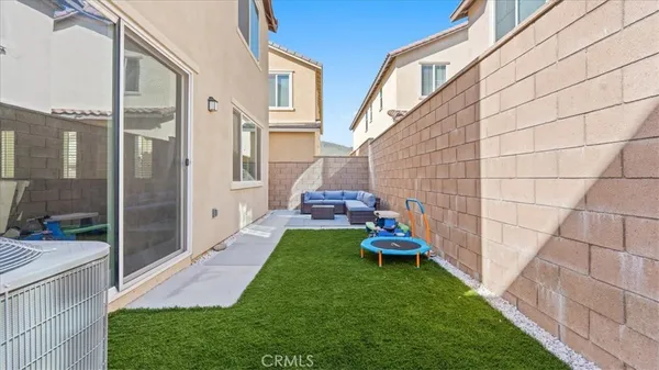 a view of a porch with furniture and garden