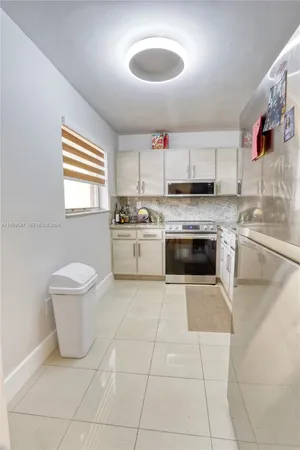 a kitchen with a stove a sink and a microwave