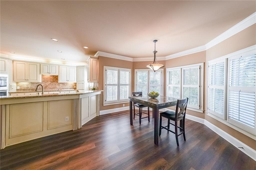 2502 Oak Hill Overlook Duluth, GA 30097 - Photo 18 of 34 a view of a dining room with furniture window and wooden floor