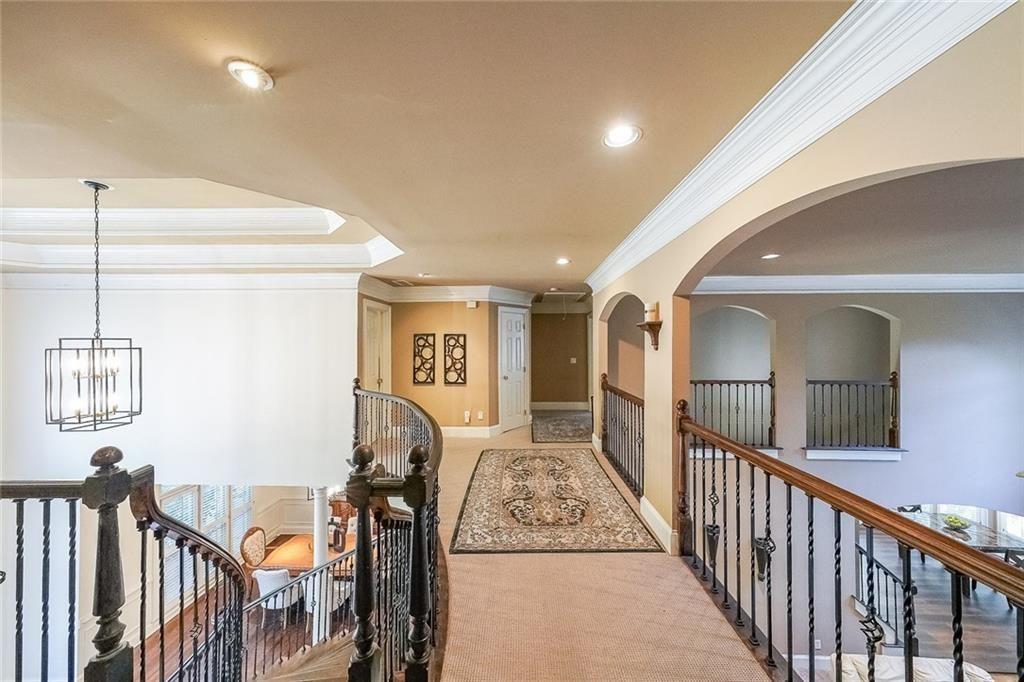 2502 Oak Hill Overlook Duluth, GA 30097 - Photo 20 of 34 a view of a hallway with wooden floor and windows