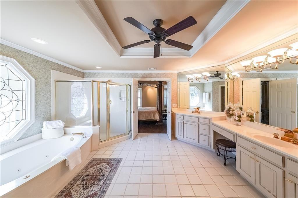 2502 Oak Hill Overlook Duluth, GA 30097 - Photo 22 of 34 a large bathroom with a large tub shower and sink