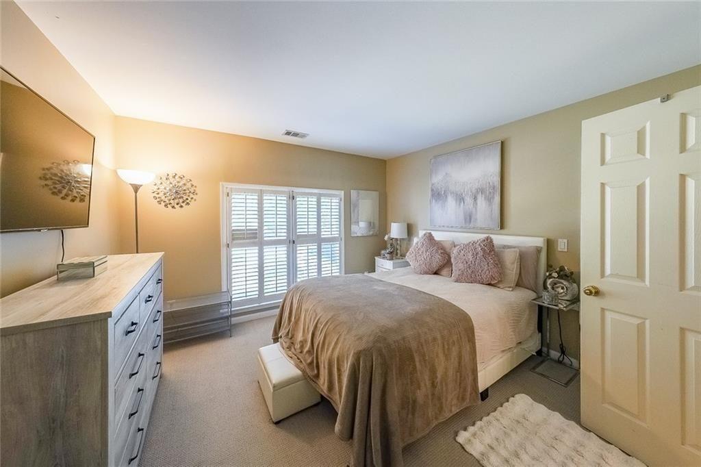 2502 Oak Hill Overlook Duluth, GA 30097 - Photo 23 of 34 a bed room with a bed and a window