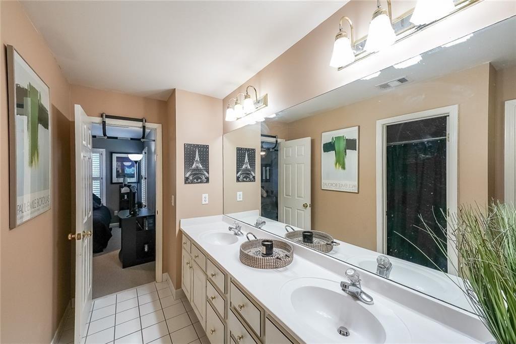 2502 Oak Hill Overlook Duluth, GA 30097 - Photo 25 of 34 a bathroom with a sink double vanity granite and a large mirror