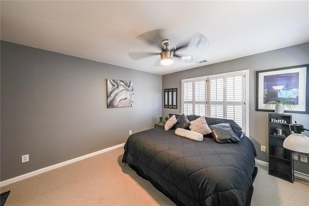 2502 Oak Hill Overlook Duluth, GA 30097 - Photo 26 of 34 a bedroom with a large bed and a window