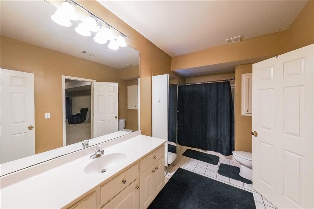 2502 Oak Hill Overlook Duluth, GA 30097 - Photo 30 of 34 a spacious bathroom with a double vanity sink and a large mirror