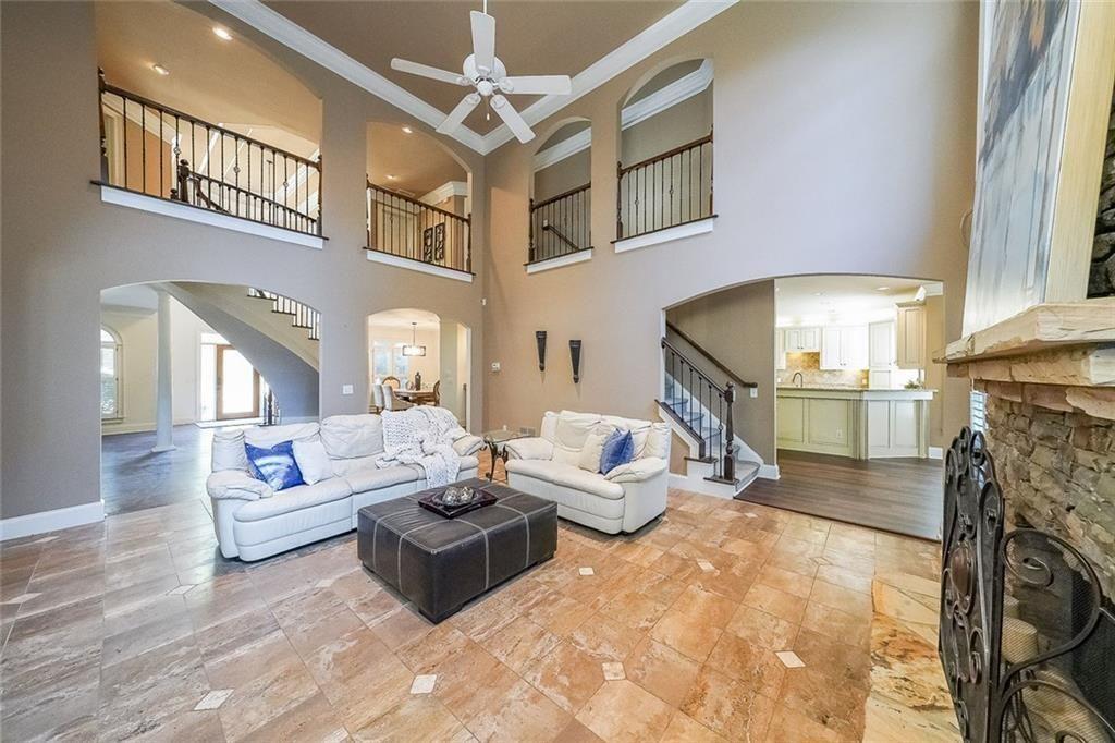 2502 Oak Hill Overlook Duluth, GA 30097 - Photo 7 of 34 a living room with furniture a fireplace and a chandelier