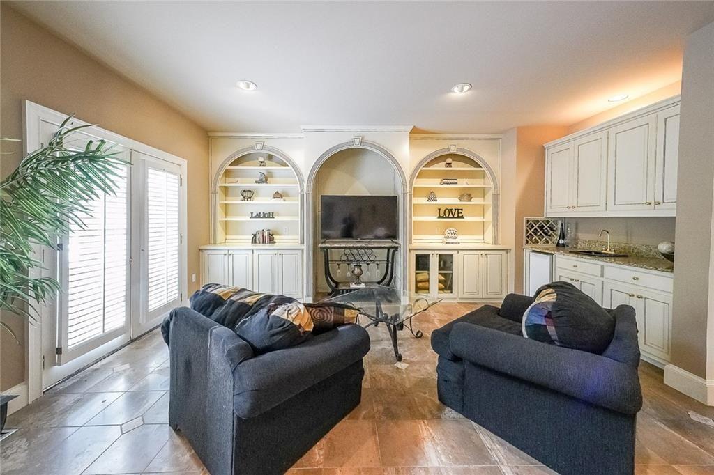 2502 Oak Hill Overlook Duluth, GA 30097 - Photo 9 of 34 a living room with furniture a large window and a fireplace