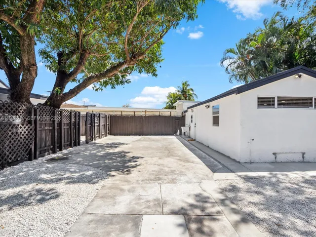 a view of a house with a yard and tree