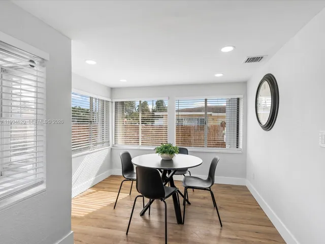 a view of a dining room with furniture window and wooden floor